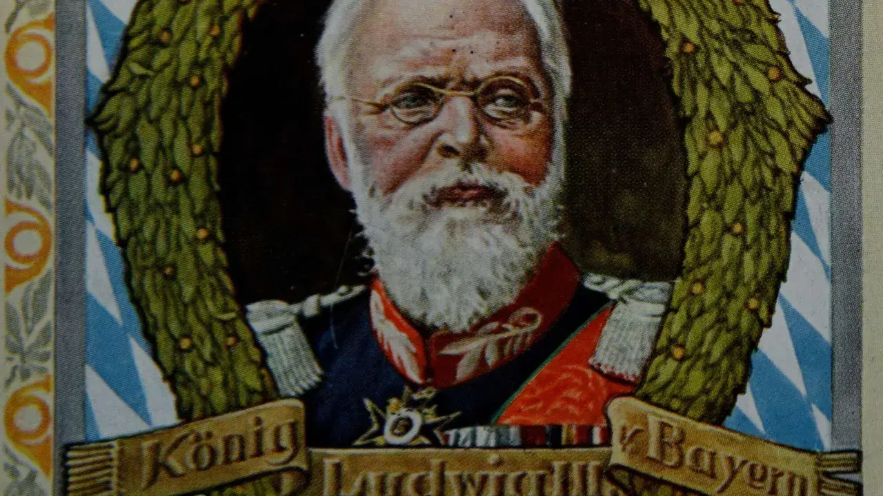 König Ludwig III. von Bayern, mit weißem Bart und Brille, umrahmt von einem Lorbeerkranz.
