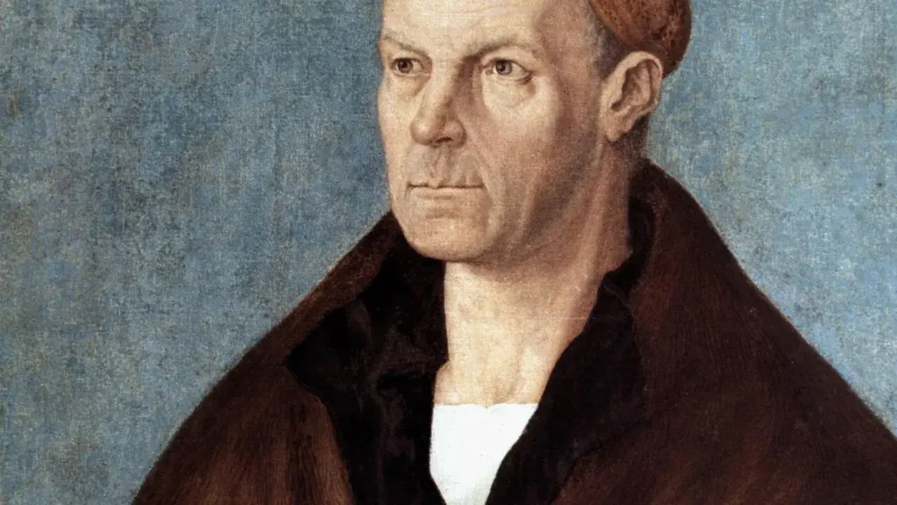 Porträt von Hans Fugger, einem wohlhabenden Kaufmann, mit ernstem Blick und braunem Mantel vor blauem Hintergrund.
