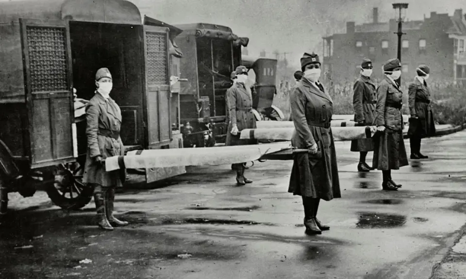 Frauen mit Masken tragen Tragen neben einem Krankenwagen. Die Szene erinnert an die spanische Grippe, wann sie die Welt heimsuchte.